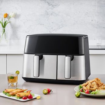 Dual basket air fryer front view with two metal baskets and glossy black top