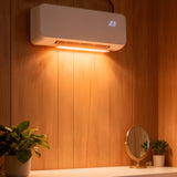 White wall-mounted PTC heater showing glowing heating slot and display '23'