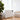 White convection heater with black control window and freestanding legs on floor