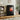 Freestanding black LED electric fireplace with glass flame window and side control panel