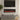 Wall-mounted electric fireplace with glowing flame effect, dark frame and glass front