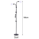 Double-headed black floor lamp with two white globe shades and round base