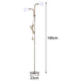 Double-headed brass floor lamp, 180 cm tall; 23 cm round base