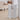 White foldable pet gate, freestanding panels with vertical slats and hinge hardware