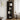 5-tier corner shelf in black with 5 open cubby levels and top shelf ledge