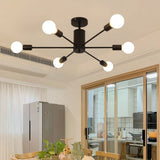 Industrial 6-light ceiling fixture with black round canopy and six white globe bulbs