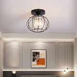 Metal lantern-style 1-light pendant with black circular canopy and clear glass cage