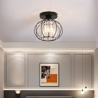 Metal lantern-style 1-light pendant with black circular canopy and clear glass cage