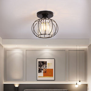 Metal lantern-style 1-light pendant with black circular canopy and clear glass cage