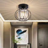 Black metal lantern pendant with clear glass cage and exposed bulbs