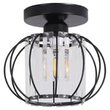 Lantern pendant close-up with clear glass cylinder and black metal ring frame