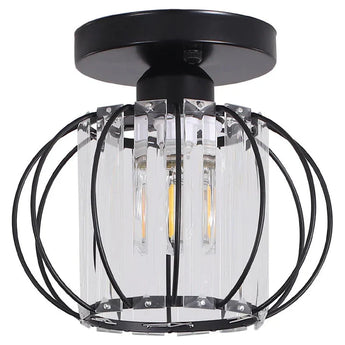 Lantern pendant close-up with clear glass cylinder and black metal ring frame