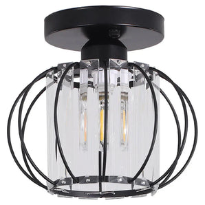 Lantern pendant close-up with clear glass cylinder and black metal ring frame
