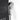Chrome handheld shower head spraying water stream from black shower panel