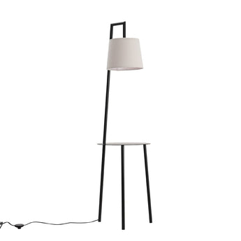Floor lamp setup with linen lampshade and round metal tray table, black finish.