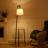 Metal tray table floor lamp with linen shade, black frame, round side tray base.