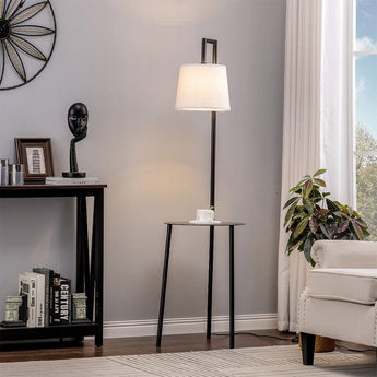 Tall floor lamp with linen lampshade and round tray table, black metal frame.
