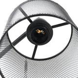 Detail of iron mesh lampshade and bulb socket on black floor lamp