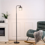 Black industrial floor lamp with metal mesh shade and exposed bulb inside