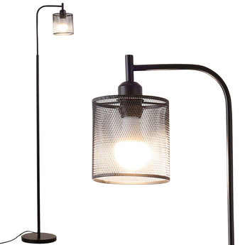 Close-up of black floor lamp with iron mesh shade and exposed bulb glow
