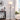 Black floor lamp with fabric drum shade and swiveling side lamp head on base