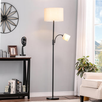 Black floor lamp with fabric drum shade and swiveling side lamp head on base