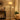 Black floor lamp with beige drum shade and adjustable side spotlight on arm