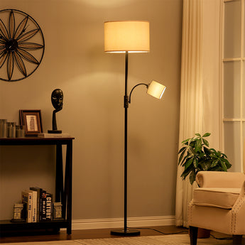 Black floor lamp with beige drum shade and adjustable side spotlight on arm