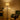 Black standing lamp with beige drum shade and curved arm spotlight head