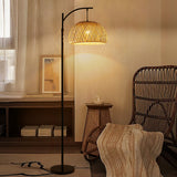 Traditional woven rattan floor lamp with dome shade and black arched stand