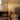 Traditional woven rattan floor lamp with dome shade and black arched stand