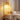 Woven rattan dome shade with black arched floor lamp frame