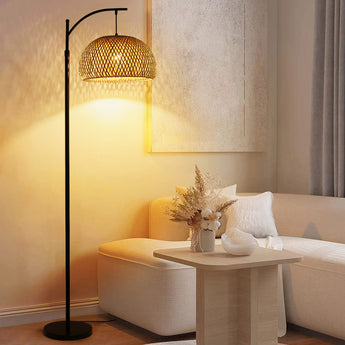 Woven rattan dome shade with black arched floor lamp frame