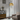 Woven rattan dome shade on black floor lamp with arched metal frame