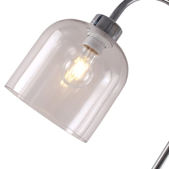 Close-up of clear glass shade showing lit filament bulb and metal mounting collar