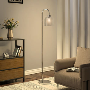 Modern standing floor lamp with arched metal frame and clear glass dome shade