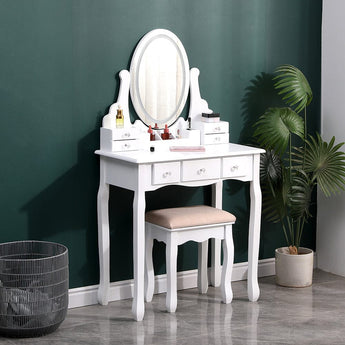White makeup vanity desk set with oval mirror, multiple drawers, and cushioned stool