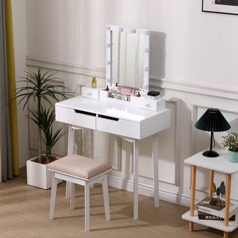 White makeup vanity table set with lighted mirror, open storage, and padded stool