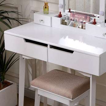 White makeup desk with lighted mirror bulbs, drawer fronts, and padded stool
