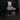 White vanity table with illuminated mirror, two drawers, and upholstered stool