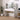 White vanity desk with lighted mirror and side shelves with bottles