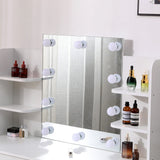 White vanity mirror with lighted bulbs and built-in side shelves for bottles