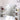 White vanity mirror with lighted bulbs and built-in side shelves for bottles