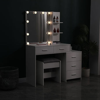 Gray vanity table with large lighted mirror and built-in shelves, plus cushioned stool