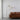 Front view of fabric floor lamp with cream dome shade and arched bronze frame
