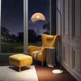Cream dome fabric lampshade on tall arched floor lamp stand in bronze
