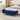 Blue chenille storage bench with tufted padded top and wooden legs