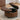 Brown round PU leather storage ottoman with lift-top and stud trim, lid opened