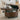 Brown round PU leather storage ottoman with lift-top, stud trim, open lid revealing storage