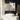 White wall-mounted mirror cabinet with open door and bathroom shelves inside